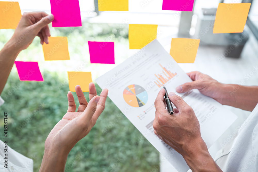 Poster business team working marketing growth on financial document graph report statistics, using post it 