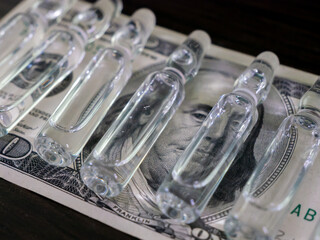 Ampoules and money dollar one hundred
