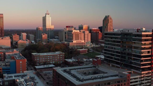 Aerial shot approaching downtown Raleigh, North Carolina at sunset.