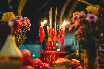 Chinese New Year Jade Emperor Praying with joss sticks and candles.