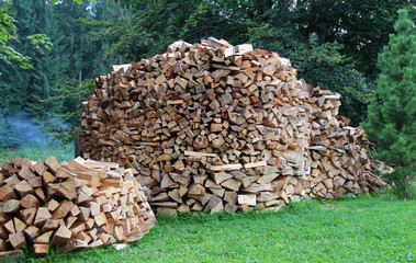 Round Woodpile On A Green Meadow
