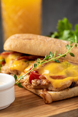 Grilled chicken and cheddar sandwich with french fries and salad.