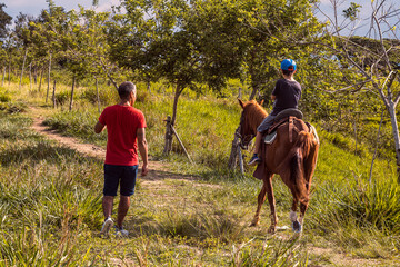 child riding horse in the field