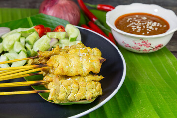 Pork satay, pork mixed with seasoning, grilled skewers served with soy sauce, cucumber, fresh chili, shallots
