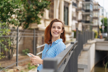 Obraz premium Joyful vivacious young woman on an urban walkway