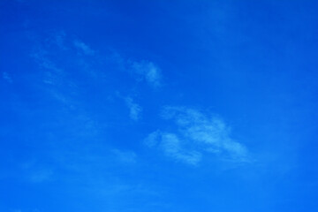 Fototapeta na wymiar Blue sky background with rich color and small clouds