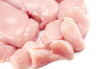 Fresh raw chicken breast fillet whole and sliced isolated closeup on white background, clipping path
