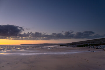 Westward Ho! beach at dusk Expansive sand beach with sunset sky.