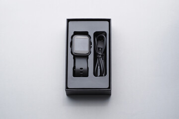 Black smartwatch in the box.