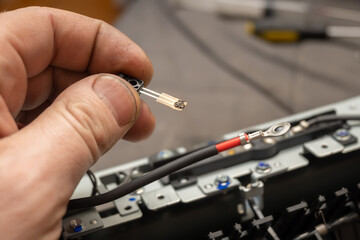 stuck dirt, dust on the thermal sensor of the printer in the hand of a repairman, foreman, service center specialist