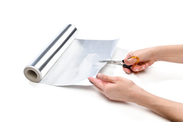 Lifehack; female hand cutting aluminum foil to sharpen scissors isolated on white background