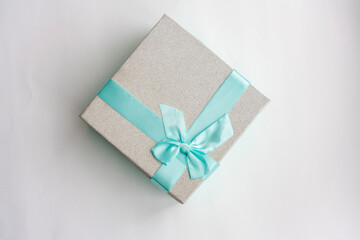 Gift box with a blue bow, isolated on a white background, top view