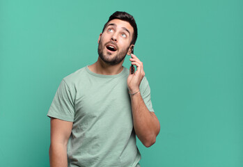 young handsome man using his cell