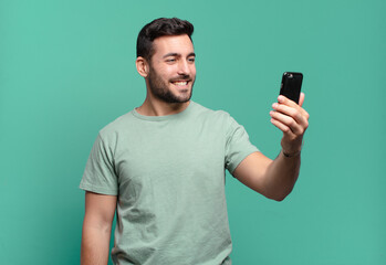 young handsome man using his cell