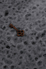 Top view of a vintage key over a rustic blurred background with copy space 