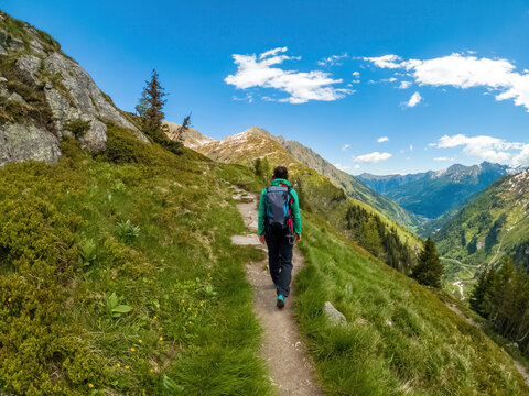 A young female hiker does trail hiking in the mountains of Gastein in Austria.