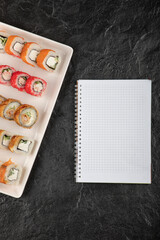 A white board of different types of delicious sushi rolls