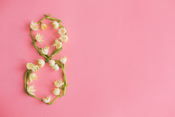 8 number made of spring flowers on pink paper flat lay. International women's day