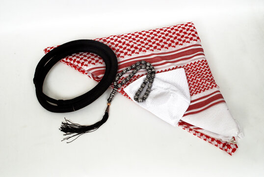 Arabic traditional clothing accessories decorated Shemagh, Agal, White Islamic cap and rosary on white background,
