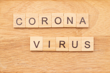 Word Corona Virus made from wooden letters on desk. Coronavirus concept.