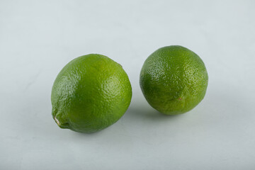 Two Fresh organic lime on white background.