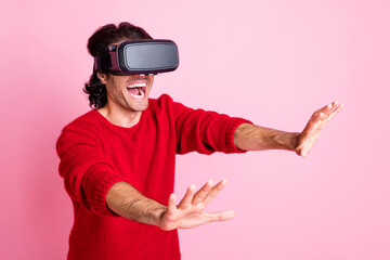 Photo portrait of impressed man laughing playing game in three-dimensional glasses isolated on pastel pink color background