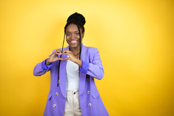 Young african american business woman smiling in love showing heart symbol and shape with hands