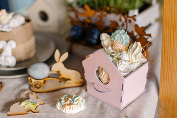 The sweets are in a house-shaped box. Decorating the festive table for Easter. Gift idea. Candy pastries meringue - a gift. original packaging of marshmallows