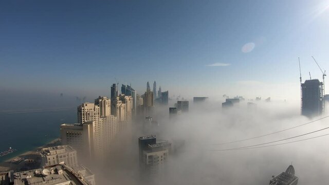 Time lapse of Dubai JBR and Marina covered in fog