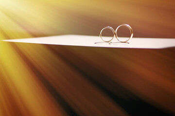 two gold wedding rings on a gray table. preparation for the ceremony.