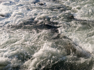 The sparkling turbulent water of the river Vrbas, rapid water movement, power of nature