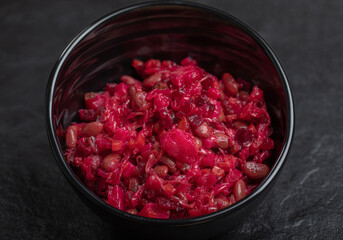 Close up photo of homemade Vinaigrette with Beans in black bowl