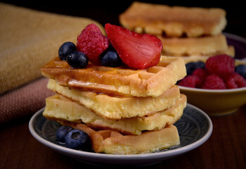 Homemade traditional belgian waffles with fresh fruits berries stock images. Fresh waffles with strawberries, raspberries and blueberries stock photo. Sweet breakfast with waffles and fruit images