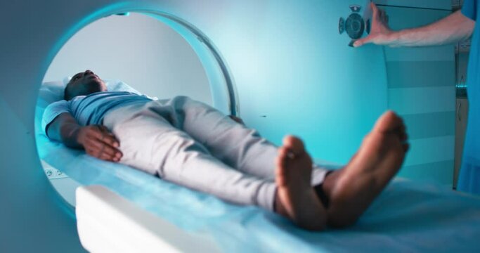 Black man during CT imaging procedure