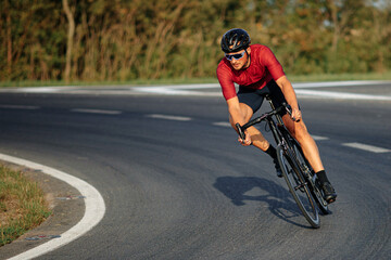 Naklejka premium Muscular guy enjoying sport activity on black bike