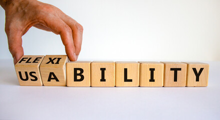 Flexibility and usability symbol. Businessman turns wooden cubes and changes words 'usability' to 'flexibility'. Beautiful white background, copy space. Business, flexibility and usability concept.