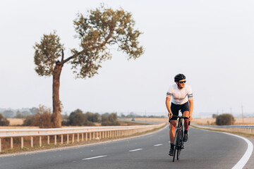 Fototapeta premium Active sportsman riding bike during sunny day