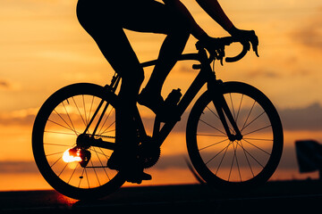 Fototapeta na wymiar Silhouette of active man racing on road during sunset
