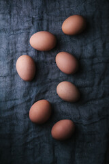 Eggs on dark fabric background. Easter, spring or eco food concept