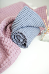 photography in pastel and bright colours. aromatherapy and spa at home, towels in lavender tones. aroma diffuser with chopsticks