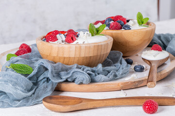 Yogurt and berries for healthy breakfast. Bowl of greek yogurt with raspberry, blueberries and strawberries