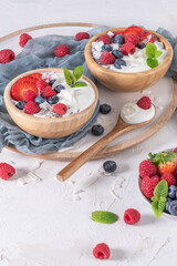 Yogurt and berries for healthy breakfast. Bowl of greek yogurt with raspberry, blueberries and strawberries