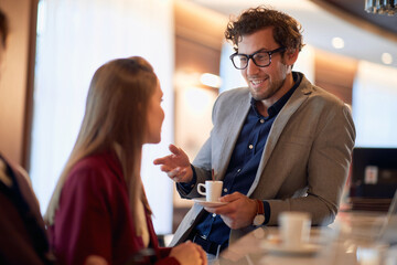 Two colleagues socializing on a coffee break