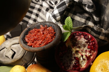 bowl with hookah tobacco. shiisha with fruits on black background.