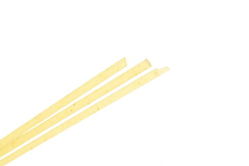 Bright yellow spaghetti, close-up, on a white background.