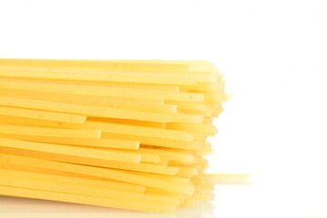 Bright yellow spaghetti, close-up, on a white background.