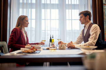 A young couple enjoying lunch at the restaurant. Couple, love, restaurant, together
