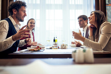 Young people talking at business lunch at the restaurant. Business, restaurant, lunch