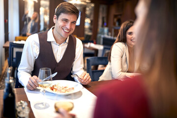 Young people having good time together at the lunch at the restaurant. Business, restaurant, lunch
