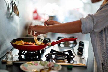 A young girl preparing a meal in the kitchen. Breakfast, kitchen, home